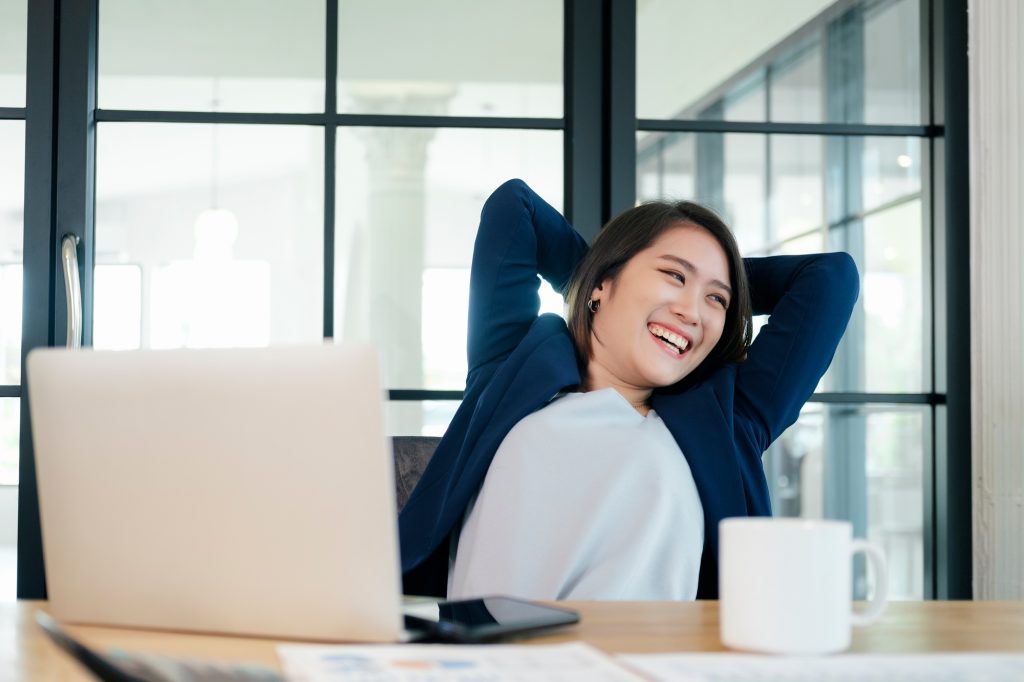 Young businesswoman relaxing at workplace in office.